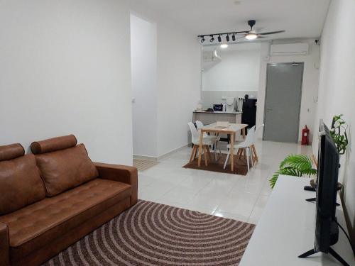 a living room with a couch and a table at The Duta Loft in Bandar Puncak Alam