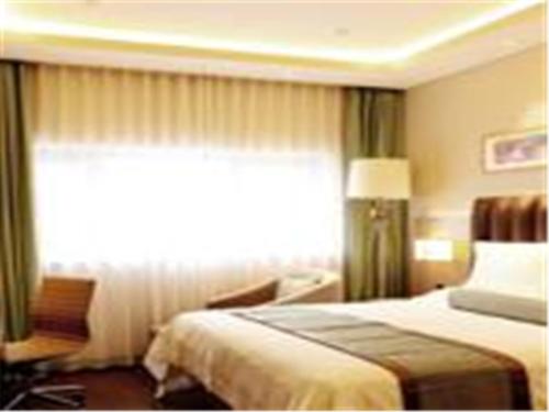 a hotel room with a bed and a window at Home Inn Ji'nan Dikou Road Railway Station North Square in Jinan