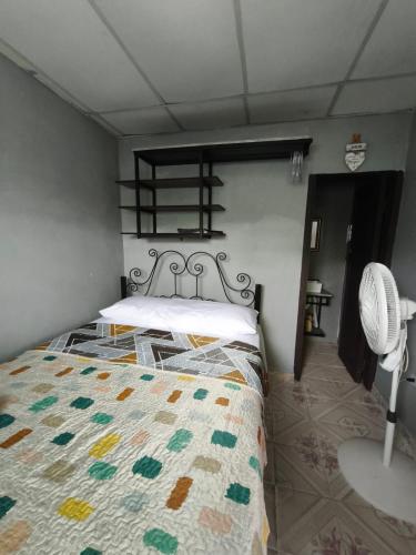 a bedroom with a bed and a fan at Yayunaturals 1 in Panama City