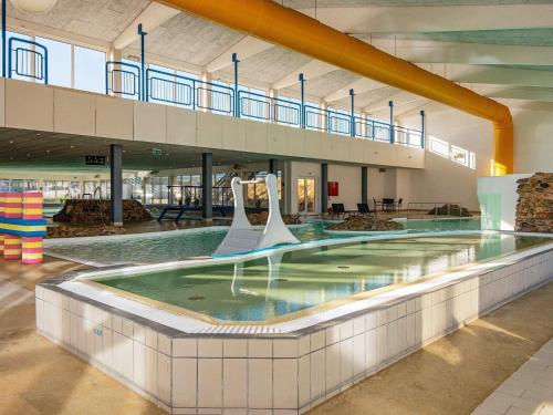 a large swimming pool in a large building at 4 person holiday home in Ringkøbing in Ringkøbing