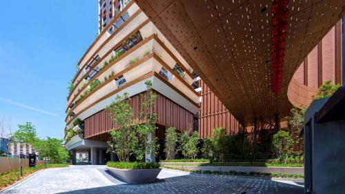 a large building with a tree in front of it at Lucentia Suites klcc by SkyPool in Kuala Lumpur