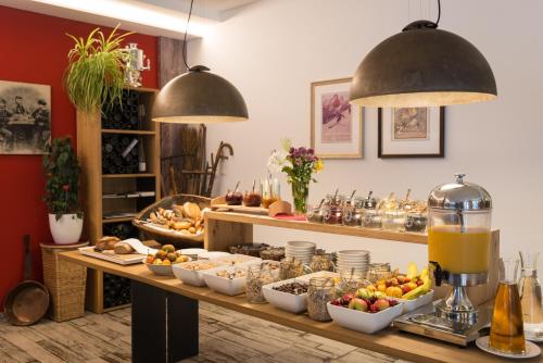 a buffet with food and drinks on a table at AlpenParks Hotel & Apartment Central Zell am See in Zell am See