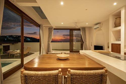 a kitchen and dining room with a table and chairs at Villa Cove 5 by BaliSuperHost in Uluwatu