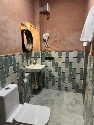 a bathroom with a toilet and a sink at Fort View in Jodhpur