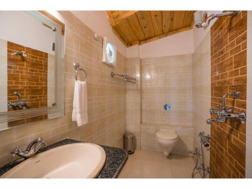 a bathroom with a sink and a toilet in it at goSTOPS Mukteshwar in Mukteswar