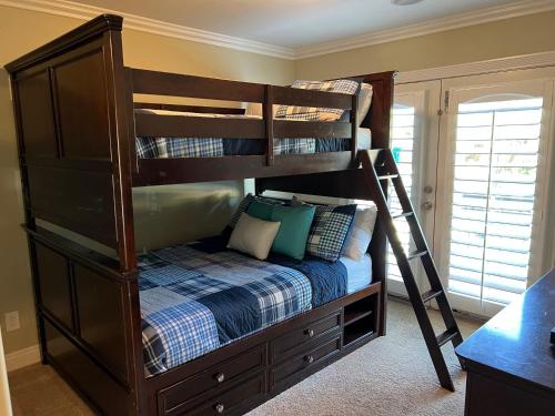 a bunk bed with a ladder in a bedroom at Destination #16 in Anaheim