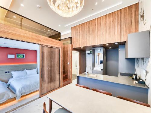 a bedroom with a bed and a kitchen with a table at Paramion Hotel in Busan