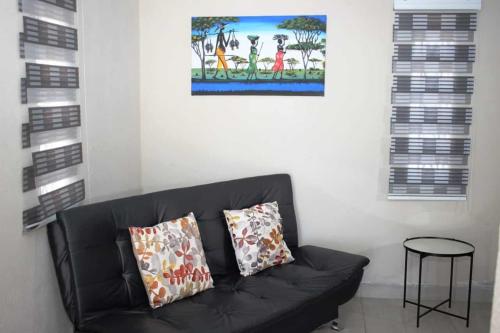 a black couch with two pillows in a living room at LESEGO LA RONA Villa in Manamakgoteng