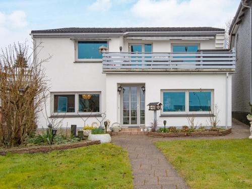 a house with a balcony on top of it at 2 person holiday home in Gråsten in Gråsten