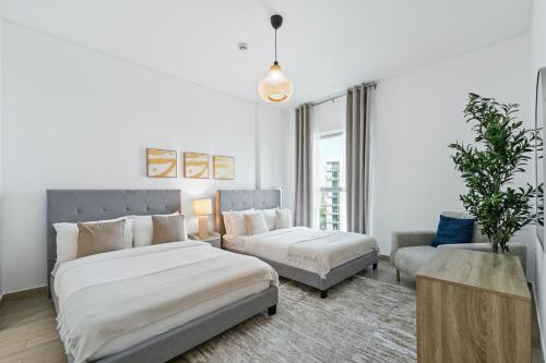 a bedroom with two beds and a couch at Yas Island 2BR Luxury Apartment by Ferrari World in Abu Dhabi