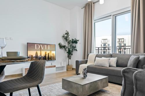 a living room with a couch and a table at Yas Island 2BR Luxury Apartment by Ferrari World in Abu Dhabi