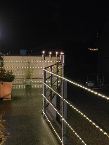 a fence with lights on it at night at Pettifer's Loft in Lincolnshire