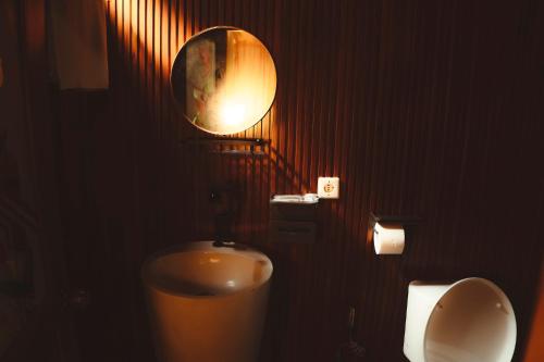 a bathroom with a toilet and a urinal and a mirror at Pelaga Eco Park in Patjung