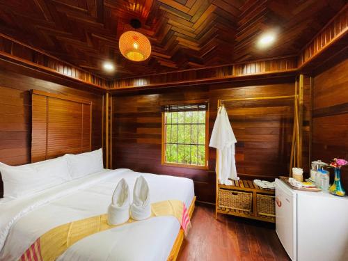 a bedroom with two beds with white shoes on them at Vvillage 