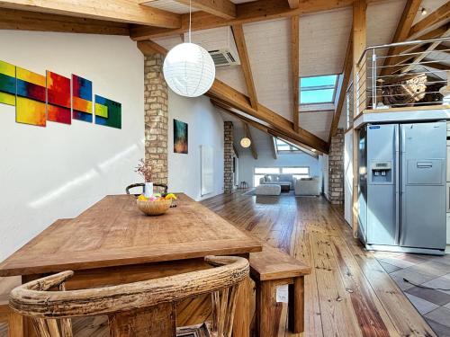 a kitchen with a wooden table in a room at HolidayHome Apartments|Luxury Loft-Style Apartment in Brandenburger Vorstadt