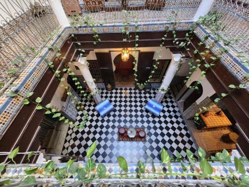 an overhead view of a hotel lobby with a checkered floor at Riad Dar Dahlia Tetouan in Tétouan