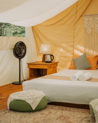a bedroom with a bed in a tent at Pelaga Eco Park in Patjung