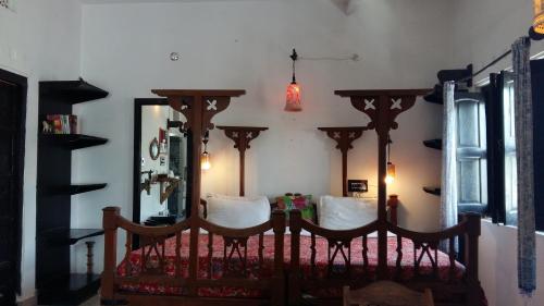 a bedroom with a bed and a mirror at Inn Seventh Heaven in Pushkar