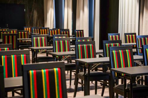 a room filled with tables and chairs with at Hotelli Sodankylä in Sodankylä