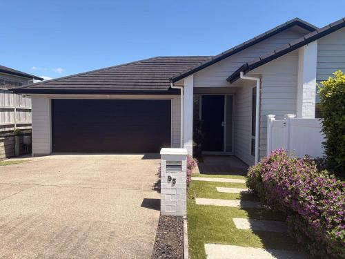 a house with a garage and a driveway at Millwater Retreat in Silverdale
