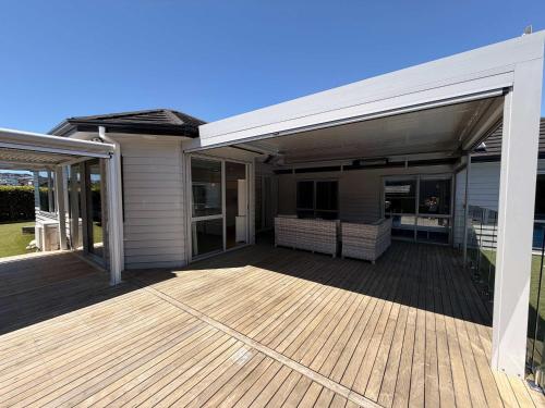 a house with a large deck with sliding glass doors at Millwater Retreat in Silverdale
