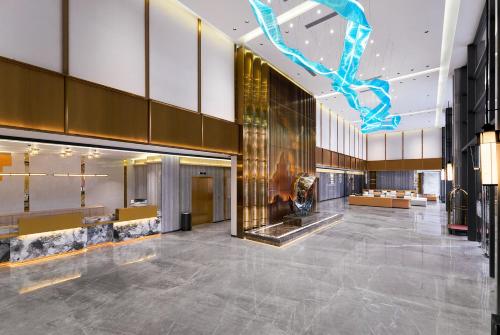 a lobby of a building with a large lobby at HARRIS Hotel & Suites Nagoya Batam in Nagoya