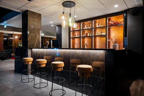 a bar in a restaurant with stools at Hotelli Sodankylä in Sodankylä