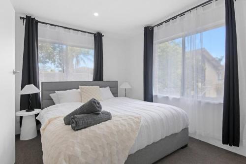 a bedroom with a large bed and a large window at The Coastal Escape - Games & Vibes in Gold Coast