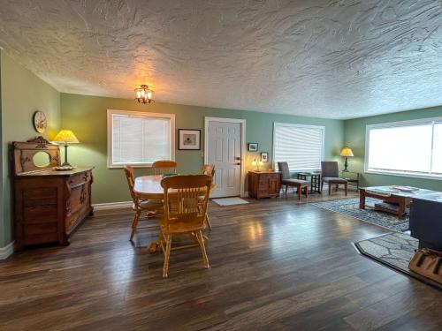 a living room with green walls and a table and chairs at The Garden Gate in R Corner