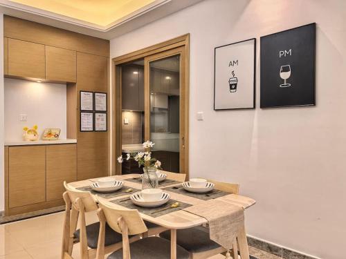 a dining room with a table and chairs at R&F Princess Cove 2BR Sea View JB CIQ Spacious in Johor Bahru