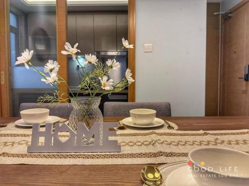 a table with a vase of flowers on top of it at R&F Princess Cove 3BR JB Central CIQ Spacious in Johor Bahru