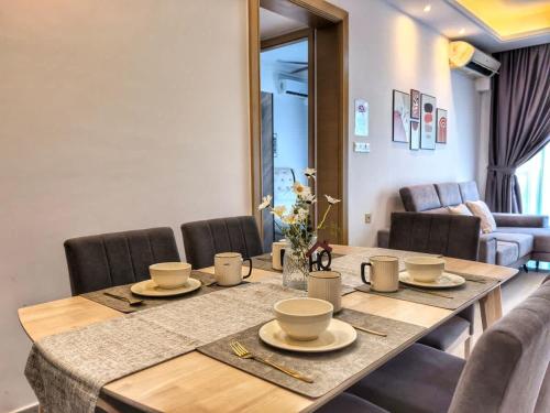 a dining room table with chairs and a tableablish at R&F Princess Cove 3BR Sea View Bathtub JB Malls in Johor Bahru