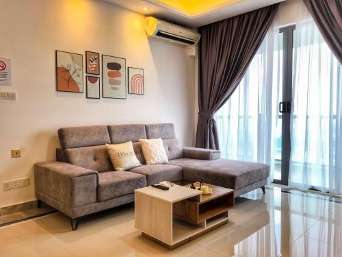 a living room with a couch and a coffee table at R&F Princess Cove 3BR Sea View Bathtub JB Malls in Johor Bahru