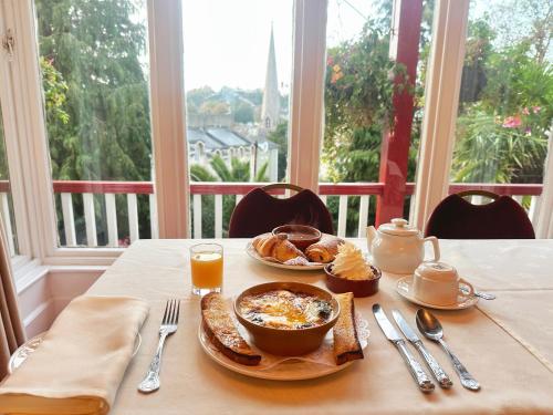 a table with a plate of breakfast food on it at The Robin Hill in Torquay