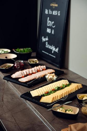 a table with several plates of food on it at Hotelli Sodankylä in Sodankylä