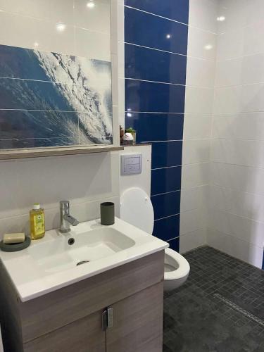a bathroom with a sink and a toilet at La kazolie in Sainte-Rose