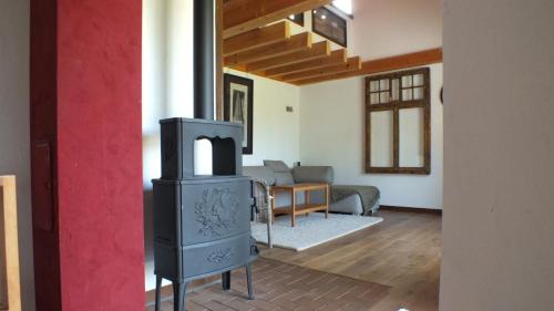 a living room with a stove and a couch at Rotes Haus in Brook
