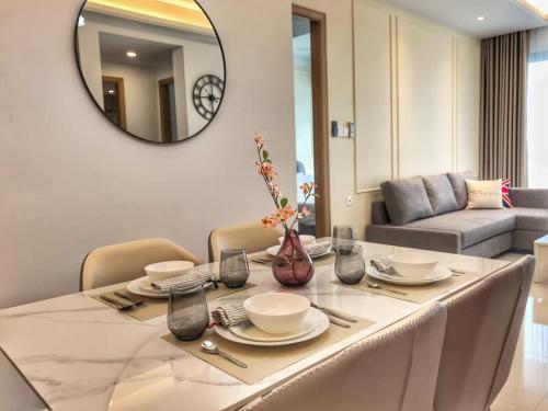 a dining room with a table with a mirror at R&F Princess Cove 2BR Sea View JB-SG CIQ Malls in Johor Bahru