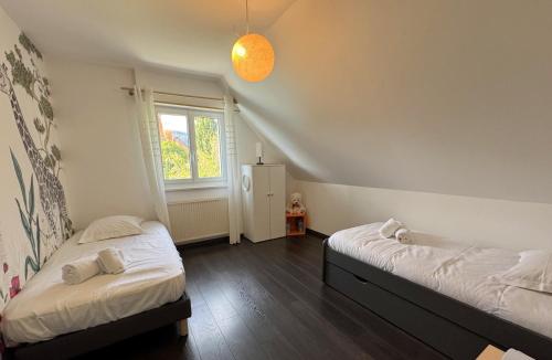 Postel nebo postele na pokoji v ubytování Vogelgarten - Maison de vacances entre vignes, et chants d'oiseaux