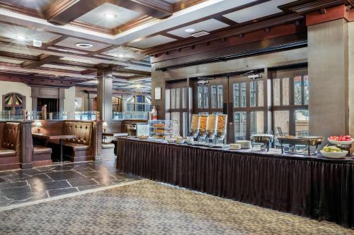 a restaurant with a bar in a building at Days Inn & Suites by Wyndham West Edmonton in Edmonton