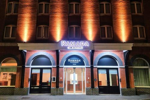 a building with a sign on the front of it at Ramada by Wyndham Belfast in Belfast