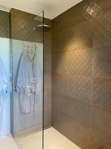 a walk in shower with a glass door at Modern 3-room apartment in Kloten