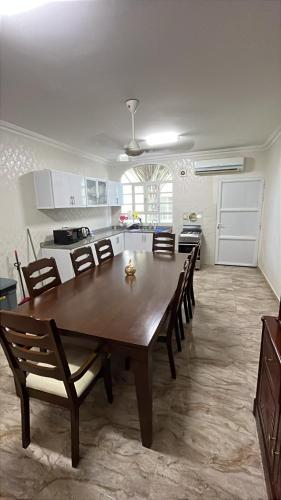 a dining room table and chairs in a kitchen at Moon villa in Seeb
