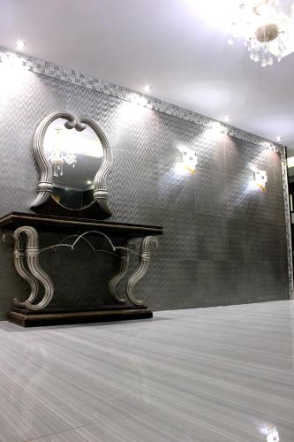 a dressing table with a mirror on a wall at Rana Palace in Amman