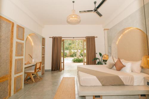 a bedroom with a bed and a desk and a table at Oura Spirit in Unawatuna