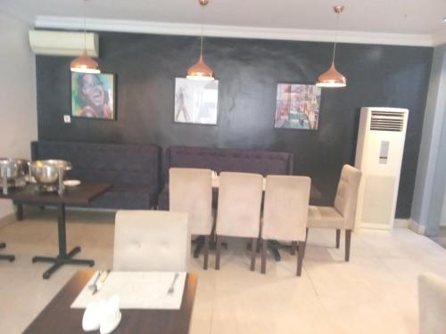 a dining room with a table and some chairs and a table and chairsktop at Chateux de atlantique Hotel in Lagos