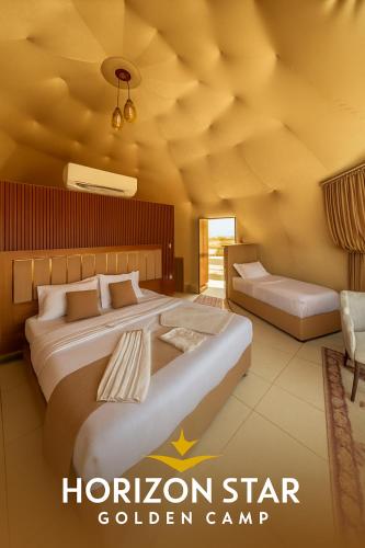 a hotel room with two beds and a couch at Horizon Star Golden Camp in Wadi Rum