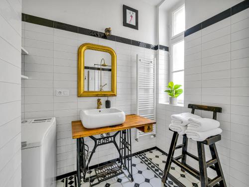 a white bathroom with a sink and a mirror at Timeless Prague Apartment by House of Huxe in Golčŭv Jeníkov