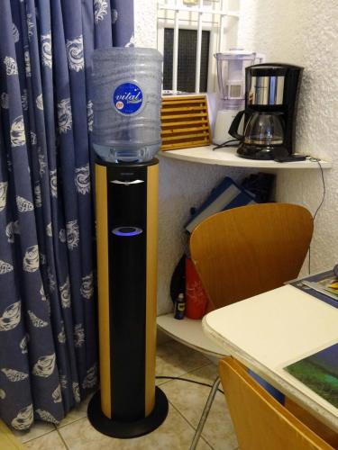 a water dispenser with a bucket on top of it at Cool Studio in Flic-en-Flac