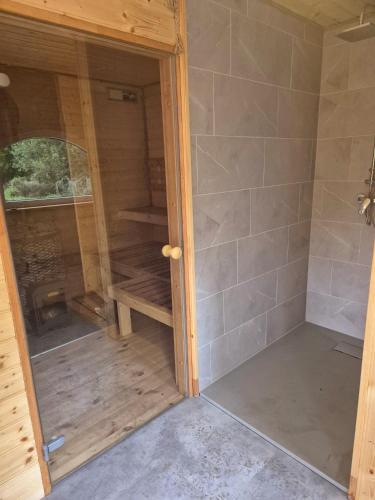 a shower with a glass door in a room at Dom Rybaka in Mirosławiec